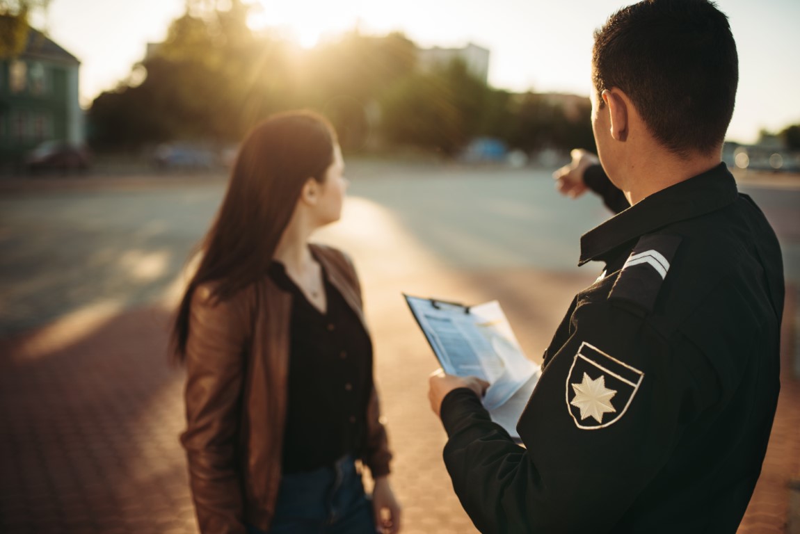 A police officer collecting a report from a civilian