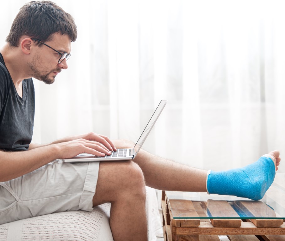 An injured person on a laptop
